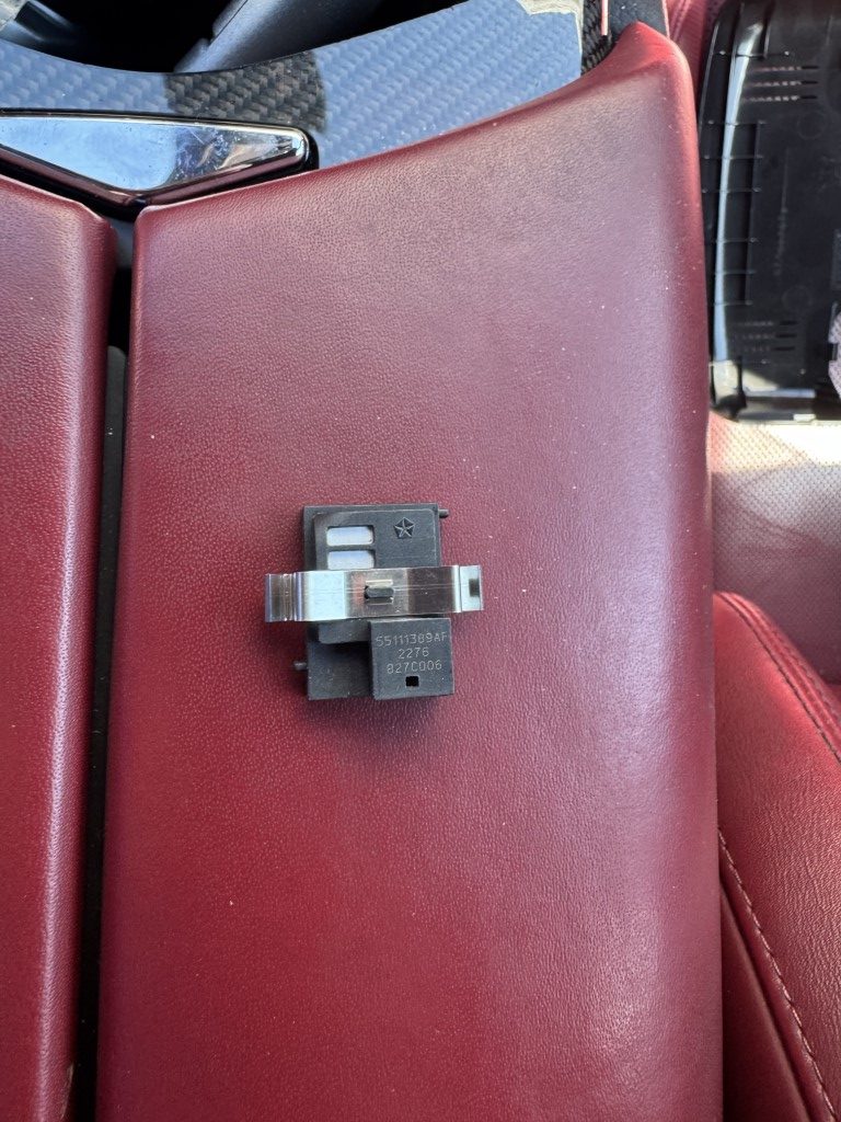 the humidity sensor sitting on the red leather center console